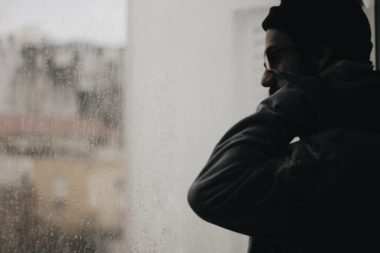 Is Hearing Loss Common in Service Members? Man stares out window.
