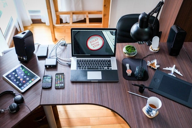 Technology and hearing loss desk covered with devices